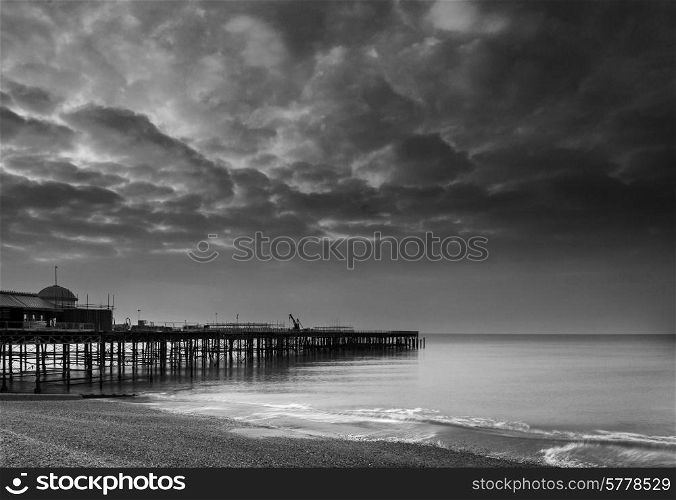 Sunrise landscape over pier under construction and development in black and white