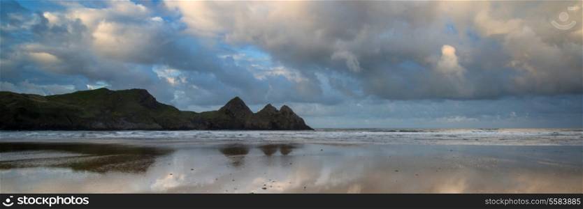 Sunrise landscape panorama Three Cliffs Bay in Wales