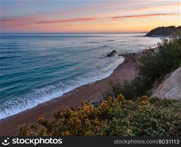 Sunrise ocean coast view from rock over beach (near Saint-Jean-de-Luz, France, Bay of Biscay).