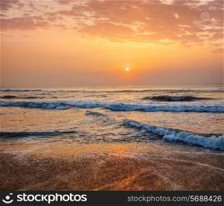 Sunrise on beach with dramatic sky