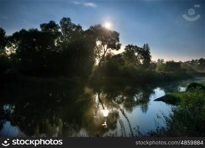 Sunrise on river with clouds and moon light above water