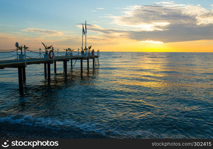 Sunrise on the sea with a pier in Kemer, Turkey
