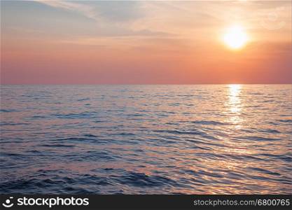 Sunrise or sunset over calm sea, pastel colors