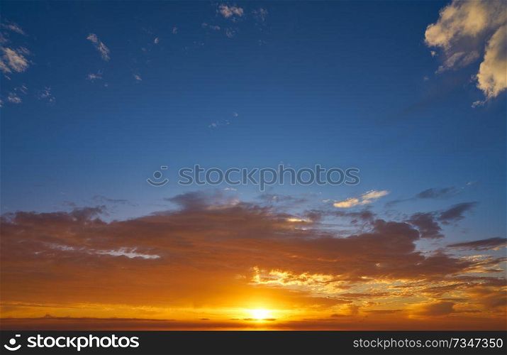 Sunrise or sunset sky with clouds in blue and orange