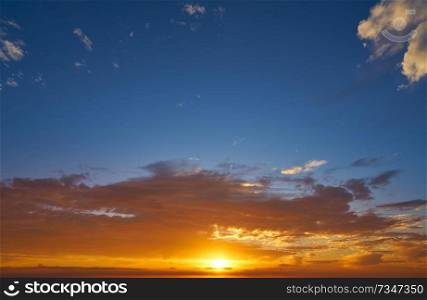 Sunrise or sunset sky with clouds in blue and orange
