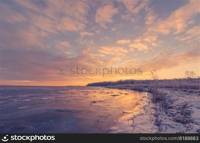 Sunrise over a frozen lake in the winter