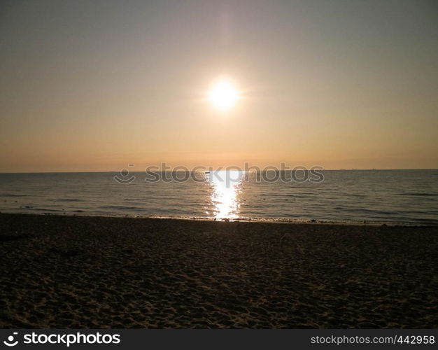 Sunrise over a sandy beach by the Baltic Sea, Poland.. Polish nature and exploration concept. Copy space.. Sunrise over a sandy beach by the Baltic Sea, Poland.