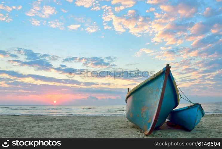 sunrise over an old wooden fishing boats