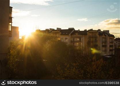 Sunrise over apartment buildings in the suburbs, the view from the window. The beginning of a new day