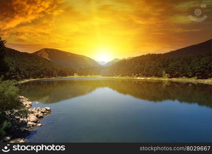 sunrise over lake and mountains