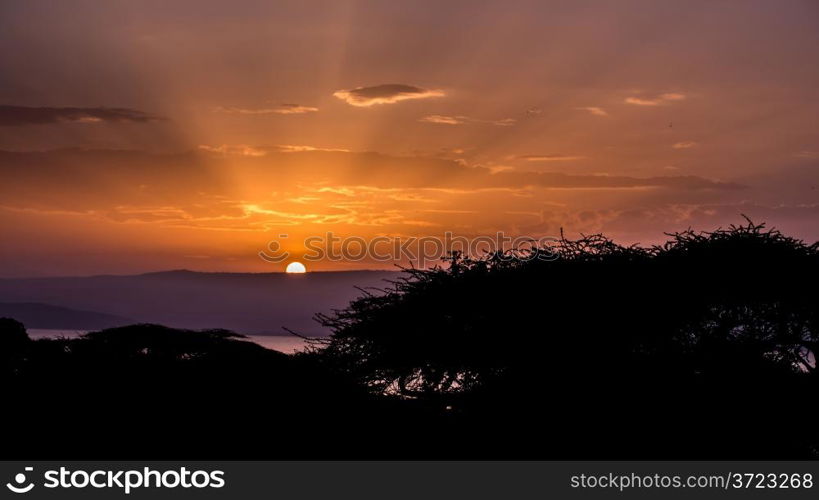 Sunrise over lake Langano. The sun rising behind the hills over lake Langano in Ethiopia.