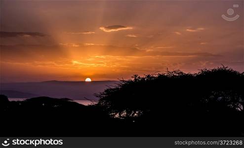 Sunrise over lake Langano. The sun rising behind the hills over lake Langano in Ethiopia.
