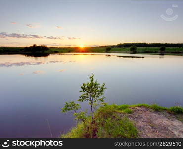Sunrise over lake. Summer sunset on a lake. Ruza reservoir in Russia.