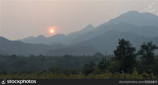 Sunrise over mountain range viewed from Great Wall Of China, Jinshanling, Beijing, China