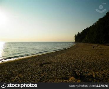 Sunrise over Orlowski Cliff and a beautiful sandy beach by the Baltic Sea, Poland. Polish nature, vacations and tourism concept.. Sunrise over Orlowski Cliff and a beautiful sandy beach by the Baltic Sea, Poland.