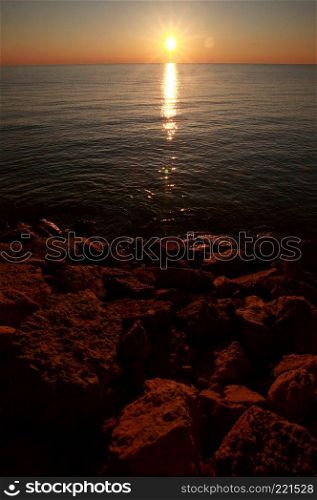 Sunrise over rocky shore of Lake Winnipeg