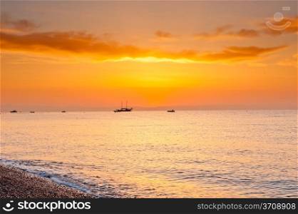 sunrise over the calm sea in orange tones