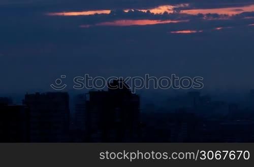 Sunrise over the city. Time lapse with panning. High angle. Aerial view.