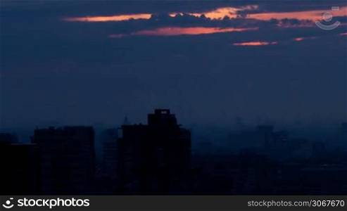 Sunrise over the city. Time lapse with panning. High angle. Aerial view.