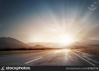 Sunrise over the road. Picturesque landscape scene and sunrise above road