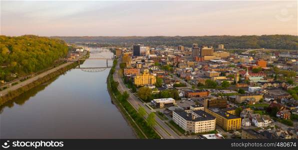 Sunrise reflects in the Kanawha River slowly flowing by picturesque Charleston West Virginia downtown