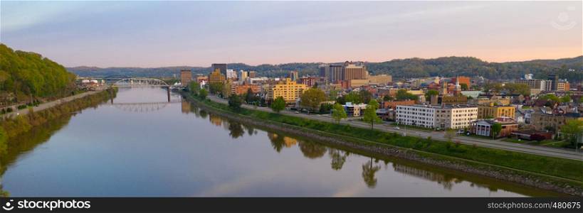 Sunrise reflects in the Kanawha River slowly flowing by picturesque Charleston West Virginia downtown