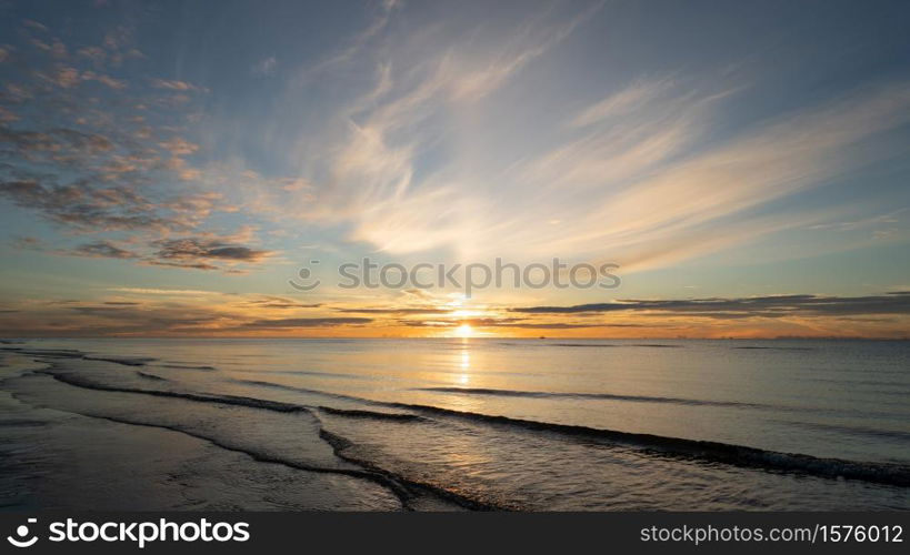 Sunrise shot over the sea and beautiful cloud. sun disappeared behind a big cloud over ocean.