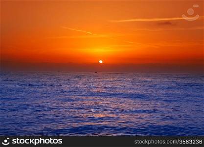 Sunrise sunset in mediterranean sea with orange sky and blue water