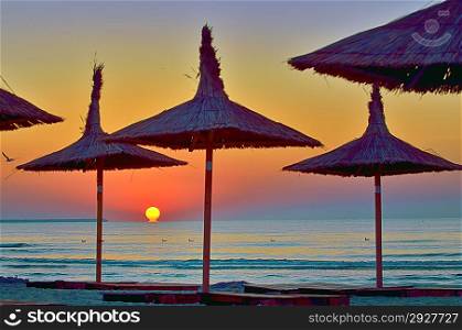 Sunrise under parasol on the Black Sea beach