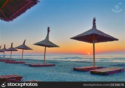 Sunrise under parasol on the Black Sea beach