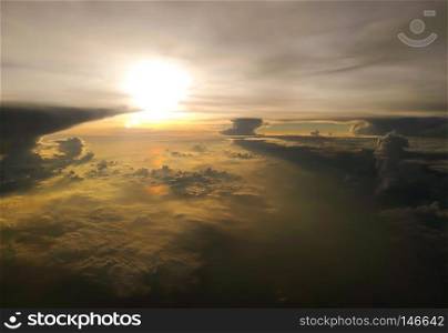 Sunrise view, taken from airplane window, with cloudscape from sky aerial view.