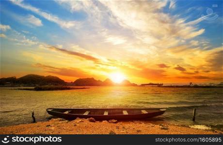 sunrise with boat on the beach