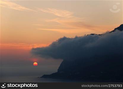 Sunset. A picturesque sunset with fantastic foggy under mountain
