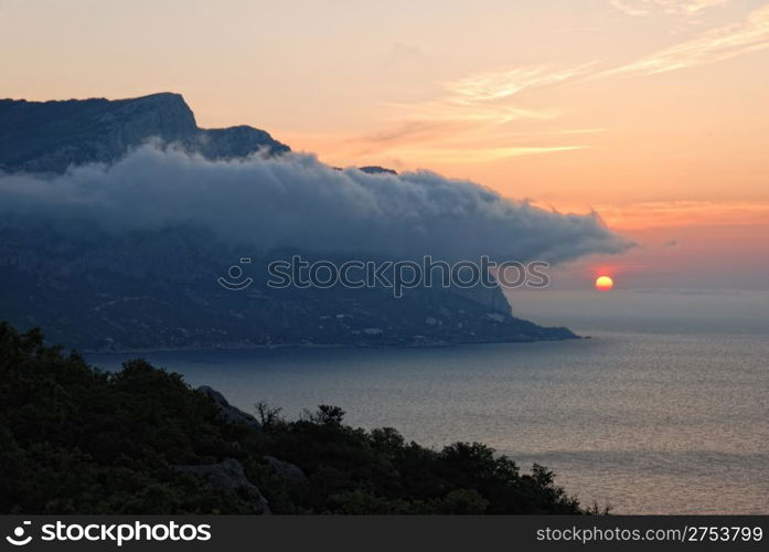 Sunset. A picturesque sunset with fantastic foggy under mountain