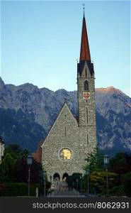 Sunset and church with high tower near Vaduz in Lichtenstein