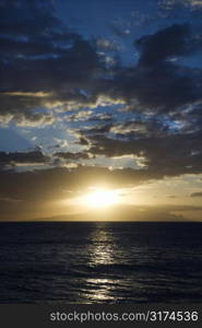 Sunset and clouds over the Pacific Ocean off the coast of Kihei, Maui, Hawaii, USA.