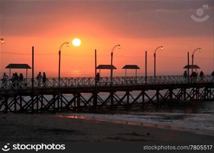 Sunset and pier on the sea coast in north Peru