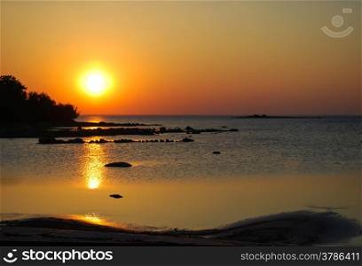 Sunset at a calm bay at the swedish island Oland.