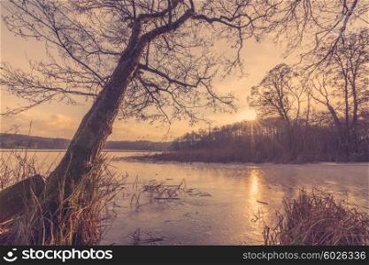 Sunset at a frozen lake in the winter
