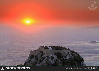 Sunset at Monolithos Venitian Castle on the west coast of Rhodes in Greece