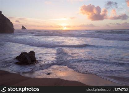 Sunset at rocky Atlantic ocean coastline of Adraga beach, Portugal. Sunset at rocky Atlantic ocean coastline of Adraga beach