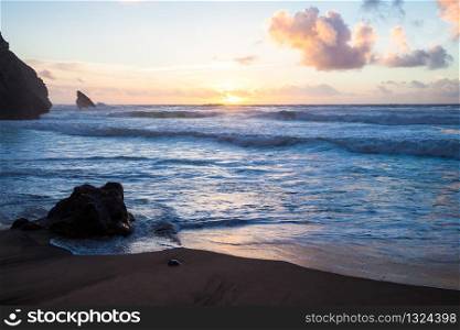 Sunset at rocky coastline of Adraga beach, Portugal. Sunset at rocky coastline of Adraga beach