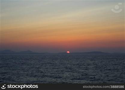 Sunset at the Portara Gate of the Apollo Temple in Naxos island