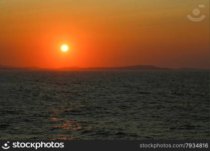 Sunset at the Portara Gate of the Apollo Temple in Naxos island