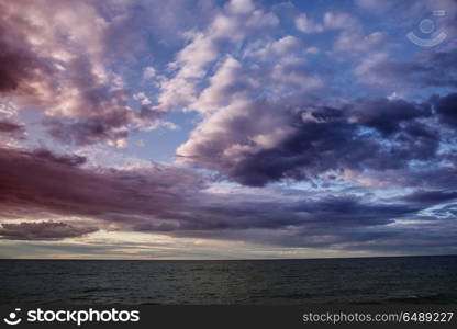 sunset at the sea. Colorful water and clouds.. sunset at the sea.