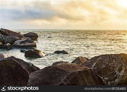 Sunset at the sea of Ilhabela island with the ocean, horizon and stones during the summer. Sunset at the sea of Ilhabela tropical island