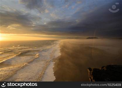 Sunset at the southcoast of iceland. Fantastic view over the foggy black sand at the beach