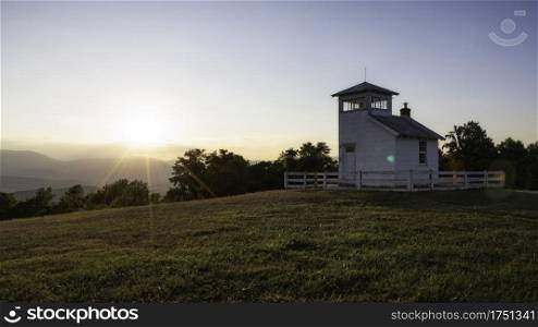 Sunset atop a hilltop meadow overlooking Shenandoah National Park. This firetower was built in the 1930 s and is steeped with local history.