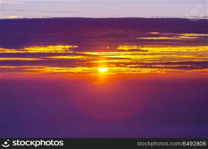 Sunset background. Unusual storm clouds at sunset. Bright red and orange colors of the sky. Suitable for background.