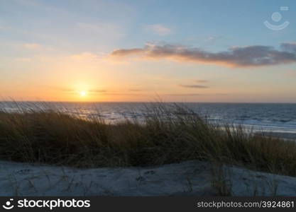 Sunset beach ocean. Sunset beach and ocean with sand dunes and clouds